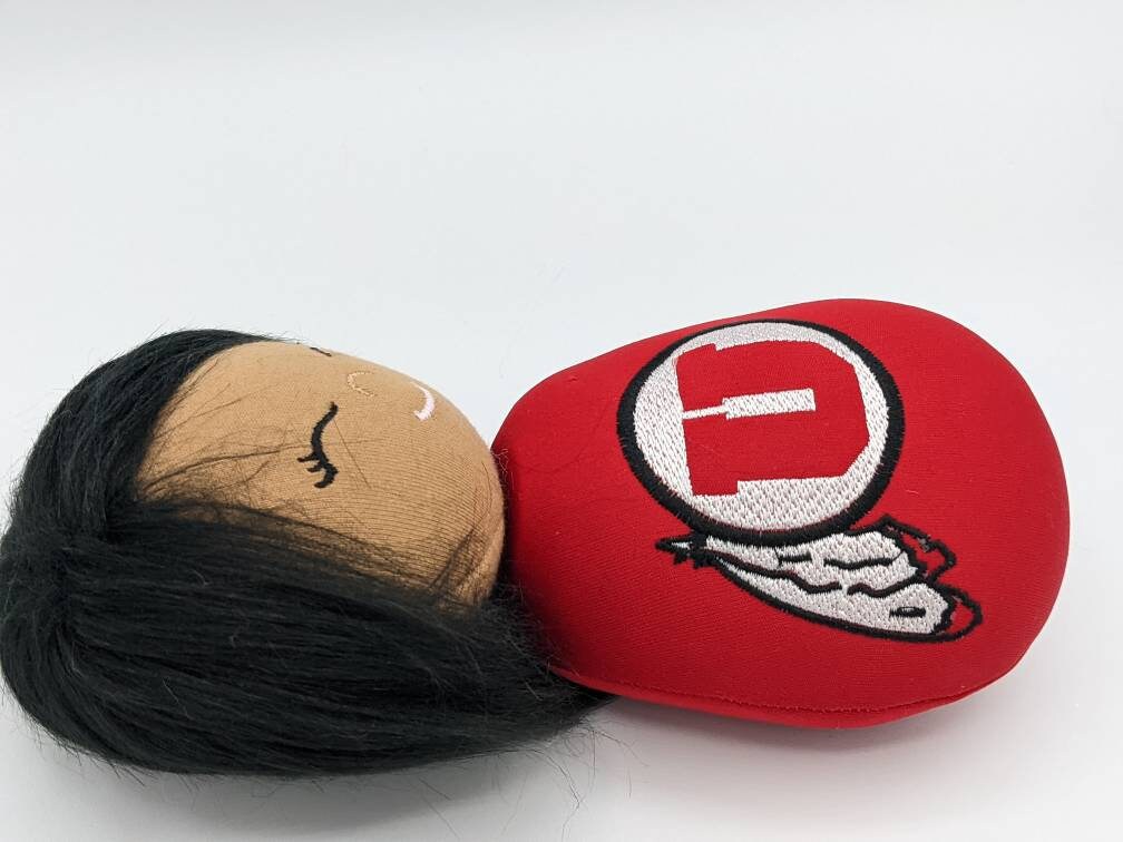 Officially licensed University of Utah 10" doll. Drum and feather.